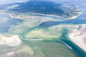 Images Dated 4th August 2019: Small boats navigate a channel between sand islands on Cape Cod, Massachusetts