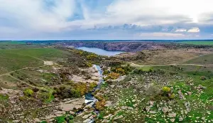Abundant Prints: A small fast stream Kamenka in the wilderness in the evening light in Ukraine