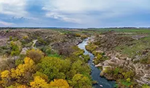 Abundant Prints: A small fast stream Kamenka in the wilderness in the evening light in Ukraine