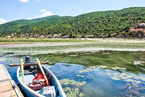 Green Hills Prints: A small fishing boat docked on the calm waters of Lake Prespa near Psarades village