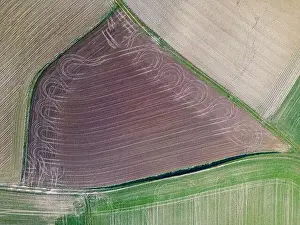 a small freshly plowed field, view from a drone in spring in germany, Aerial top view