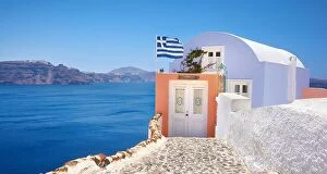 Images Dated 27th June 2011: Small house with greek flag, Oia Town, Santorini, Cyclades Islands, Greece