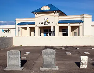 A small paved-over cemetery sits in the middle of a mall parking lot in Greenville
