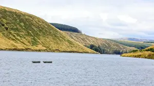 Row Boat Prints: Two small rowing boats moored out on a Scottish Loch