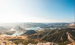 Small tranquil lake located in valley near beautiful mountain on sunny day in Spain