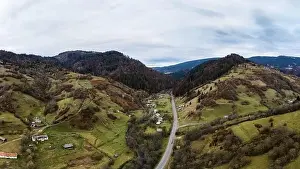 Small village in a mountain valley of the Carpathian Mountains on an autumn day in Ukraine along a road