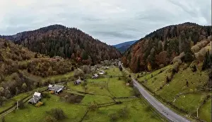 Carpatian Prints: Small village in a mountain valley of the Carpathian Mountains on an autumn day in Ukraine along a road