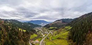 Carpatian Prints: Small village in a mountain valley of the Carpathian Mountains on an autumn day in Ukraine along a road