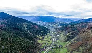 Carpatian Prints: Small village in a mountain valley of the Carpathian Mountains on an autumn day in Ukraine along a road