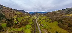 Carpatian Prints: Small village in a mountain valley of the Carpathian Mountains on an autumn day in Ukraine along a road