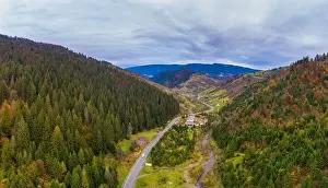 Small village in a mountain valley of the Carpathian Mountains on an autumn day in Ukraine along a road