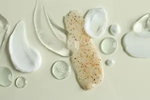 Lotion Prints: Smears of different cosmetic products on white background, flat lay