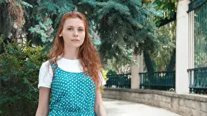 Redhead Prints: Smiling beautiful red-haired woman outdoor