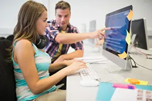 Revision Prints: Smiling classmates doing an assignment together in the computer room