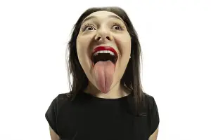 Montage Prints: Smiling girl opening her mouth and showing the long big giant tongue isolated on white background