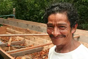 Carpenter Prints: A smiling man by his half-finished canoe in the Brazilian Amazon