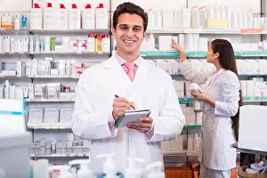 Dispensary Prints: Smiling pharmacist and pharmacy technician posing in pharmacy