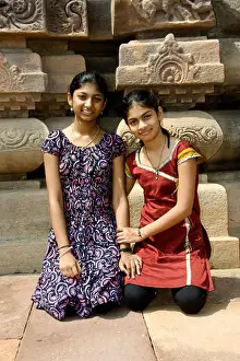 Jolly Prints: Two smiling sisters sitting at the backdrop of temple at Pattadakal in Bagalkot district