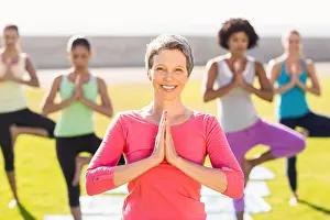 Working Out Prints: Smiling sporty woman doing yoga in yoga class