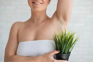 Imitation Prints: Smiling woman in a white towel holds a pot with a plant