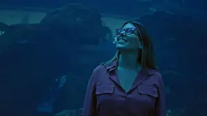 Latina Prints: A smiling young adult woman experiences the marine wonders at an aquarium in dubai