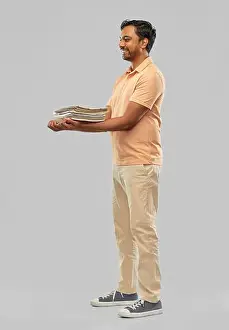 Reuse Prints: smiling young indian man sorting paper waste
