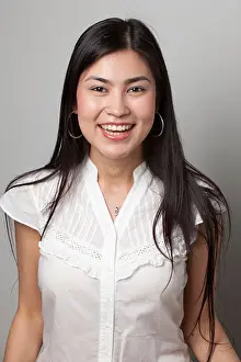 Studio Portrait Prints: Smiling young woman with long dark hair wearing a white blouse and hoop earrings