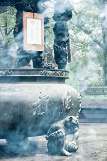 Smoky Prints: Smoke from incense wraps around metal scuptures at Lingyin Temple