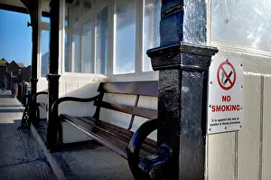 Prohibited Prints: A No Smoking sign on a beach side promenade shelter on the seafront in Hastings East Sussex UK