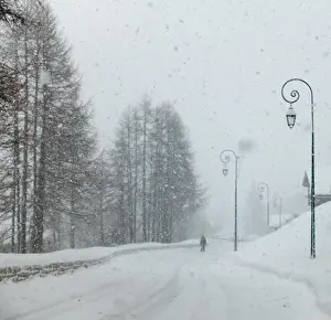Snowing Prints: snow falling snowing on a road street scene in the French Alpes with ornate lamp post posts