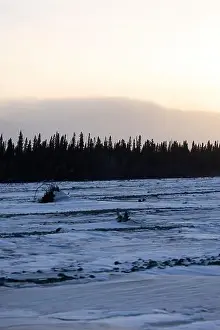 Delta Junction Prints: Snow on frozen river with trees and mountains in the background on the winter solstice in interior Alaska