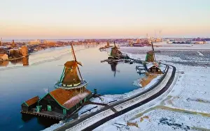 Cold Weather Prints: Snow at the Zaanse Schans windmill village during winter with snow landscape in the Netherlands Holland village