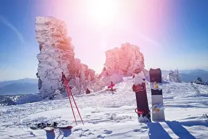Vacation Village Prints: Snowboard and ski on background of snowy mountain and blue sky with sun light