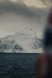 Brim Prints: Snowy mountain behind Norwegian flag in the arctic Lyngen Alps