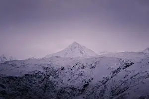 Brim Prints: Snowy mountain peak under pink sky clouds in the Lyngen Alps in northern Norway