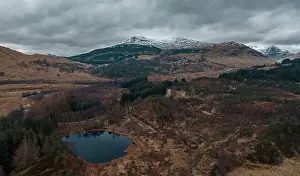 Capped Prints: Snowy mountain range in Scottish Highlands at winter - drone point of view