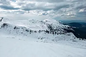 Mountain Peak Prints: A snowy mountains Kizly and Hoverla with a cloudy sky in the background