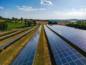 Solar Panels Prints: Solar panels in rows on a solar farm in the countryside in sunshine in autumn