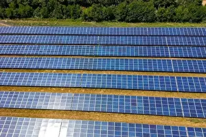 Solar Panels Prints: Solar power plant with rows of photovoltaic modules in a rural area next to a forest