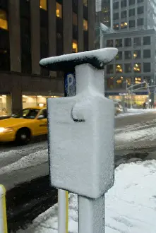Debit Prints: A solar powered muni meter encrusted with ice and snow in midtown Manhattan in New York