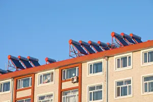 Green Energy Prints: solar water heaters on an apartment roof in Suihua city in northern China