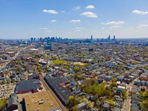 Somerville city center aerial view on Somerville Avenue with Boston skyline at the background in spring