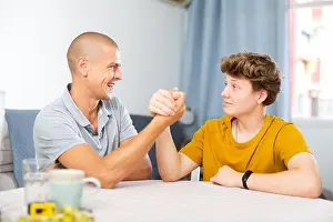 Fatherhood Prints: Son and his dad arm wrestling