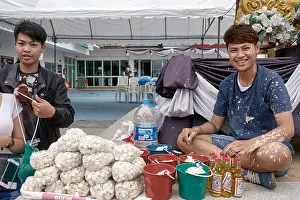 Merit Prints: Songkran Thailand. Young Thai people selling white powder at Thailand Songkran water festival