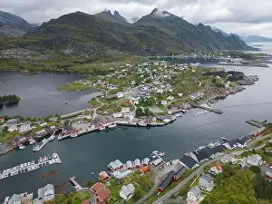 Vacation Village Prints: Sorvagen city aerial cloudy view with harbor and rocky mountains, Lofoten Norway