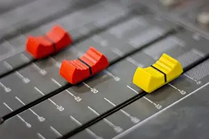 Knob Prints: Sound control volume slide.Professional audio mixer in recording room