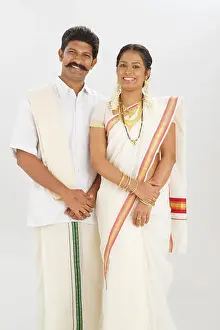 Young Couple Prints: South Indian couple standing together and smiling