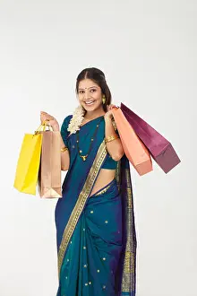 20 24 Years Prints: South Indian woman carrying shopping bags and smiling