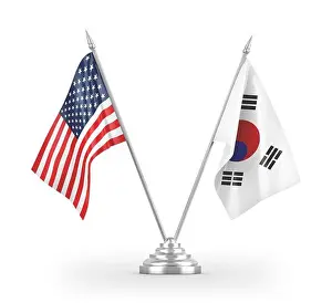 Paired Prints: South Korea and United States table flags isolated on white 3D rendering