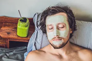 Teenage Prints: Spa man applying Facial green clay Mask